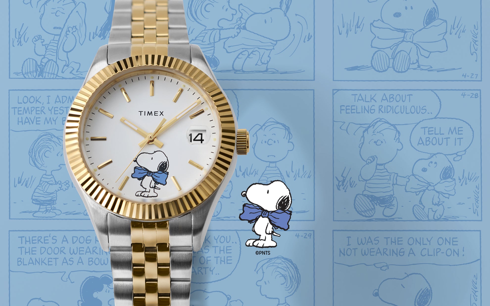 Timex x Peanuts® Timex Legacy watch in silver and gold-tone with white dial and Snoopy in a blue bow tie, displayed against a blue background with Peanuts® comic strip panels.