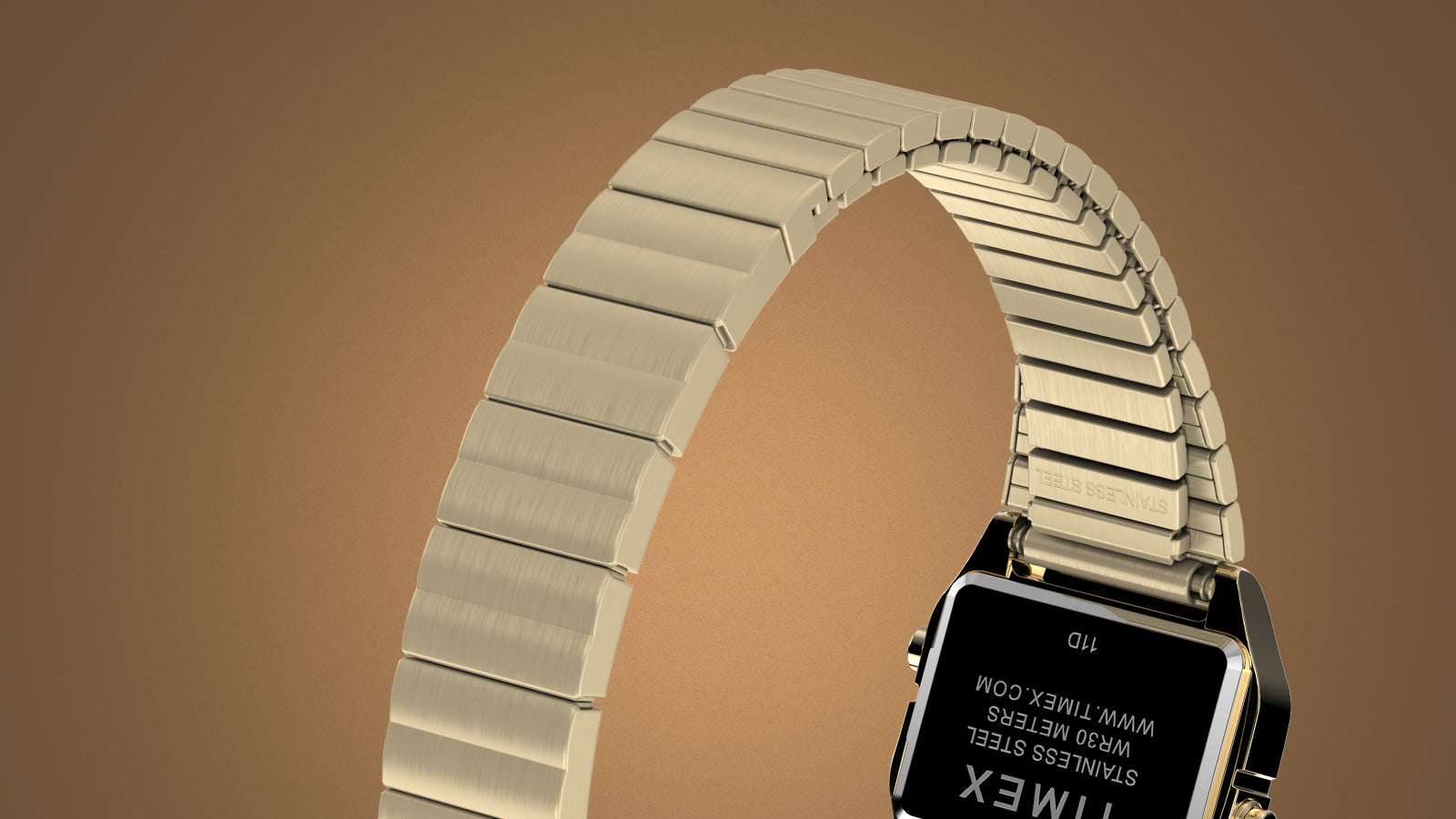 Rear angled view of the gold-tone Teeny Tiny Timex digital watch, focusing on its brushed stainless-steel expansion band and engraved case back. The detail emphasizes the durable, vintage-inspired construction and Timex branding.