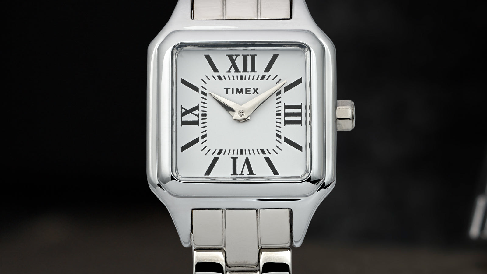 Close-up of the Timex Legacy Addison silver-tone square watch showing white Roman-numeral dial and link bracelet.