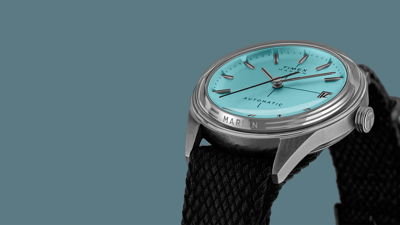 Timex Marlin Jet Automatic showing the polished stainless-steel case, crown, and black fabric strap.