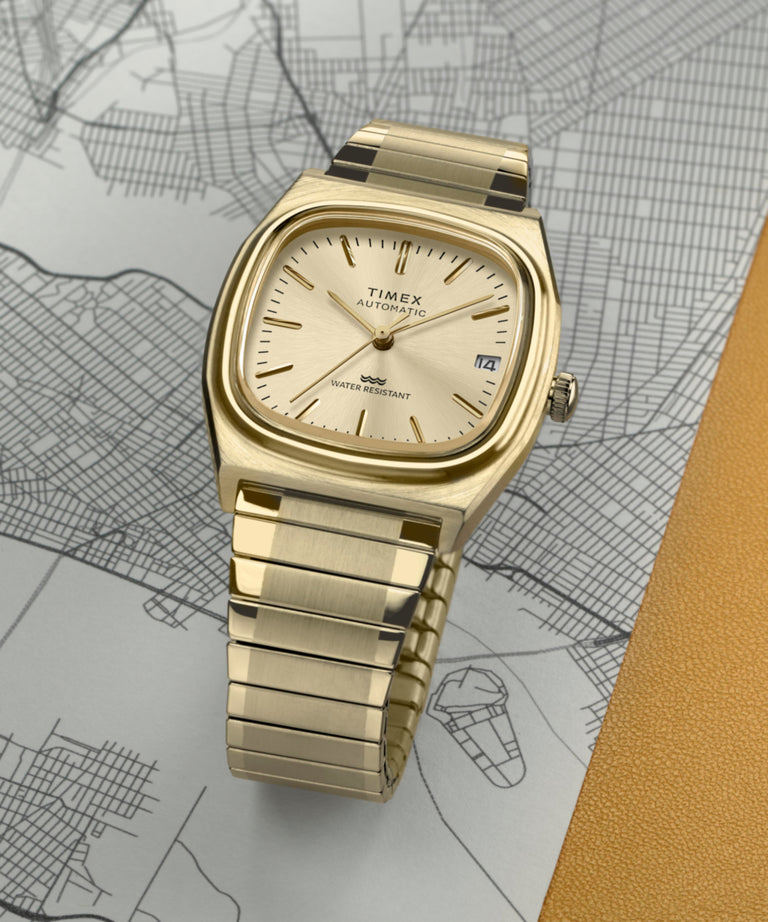 TW2Y07200 Timex® Automatic 1983 E Line Reissue 34mm Gold-Tone Expansion Band Watch Campaign Key Silhouettes (Beauty shots) Image