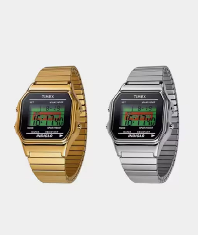 Two digital watches shown one in gold, the other in silver