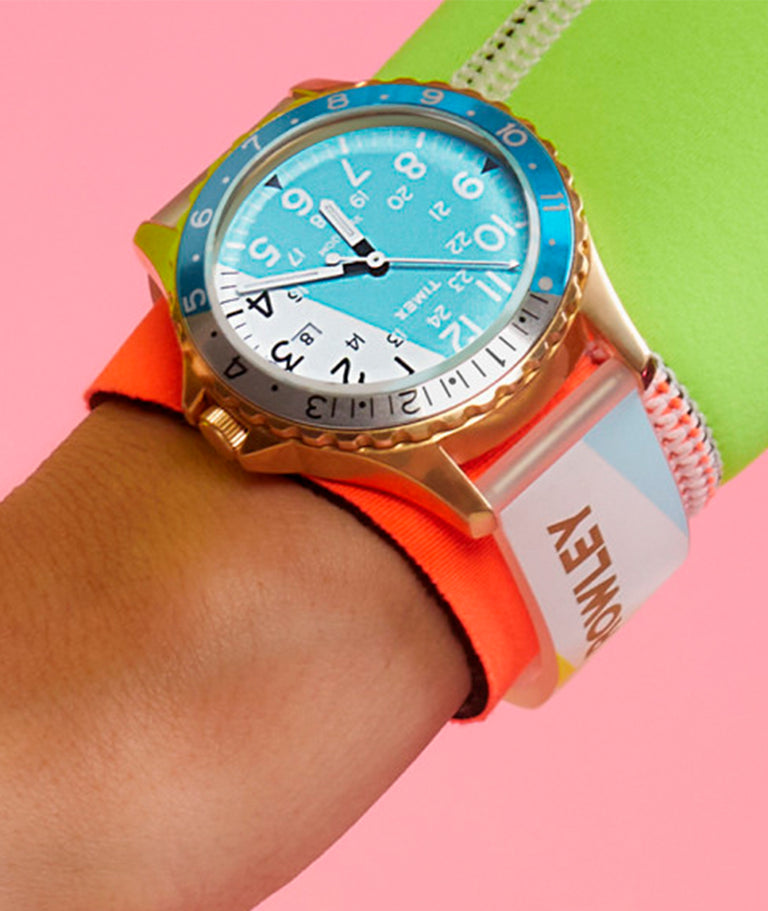 Bright multi-colored watch on a womans wrist with colorful clothing