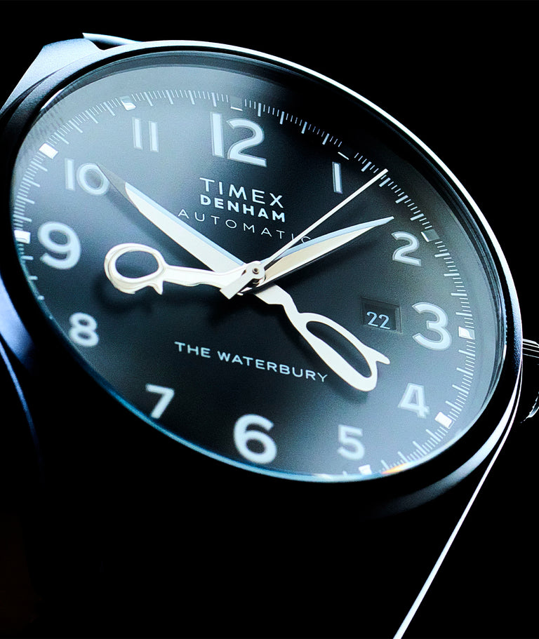 Up close of watch dial showing scissors as the watch hands