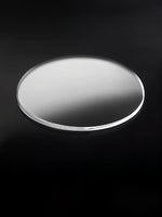Round metallic object on a black background