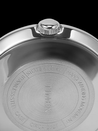 Close-up of a watch case with brand engraving on a black background