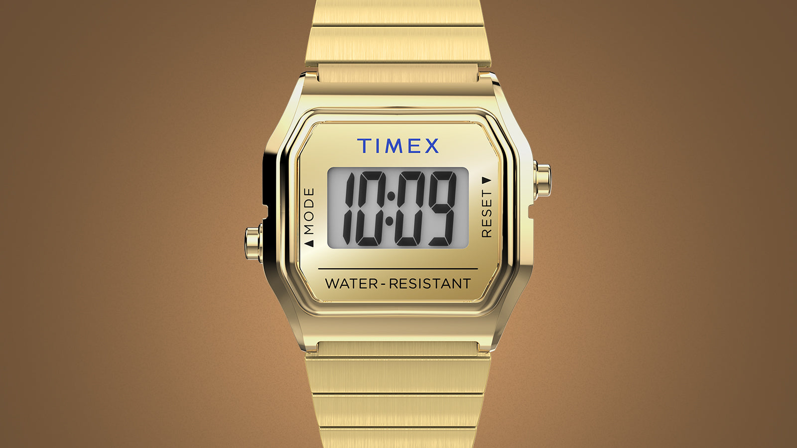 Front view of the gold-tone Teeny Tiny Timex digital watch displaying the time “10:09” on its minimalist LCD screen. The compact square case, polished finish, and stainless-steel bracelet highlight the vintage-inspired elegance of the Dimepiece collaboration.