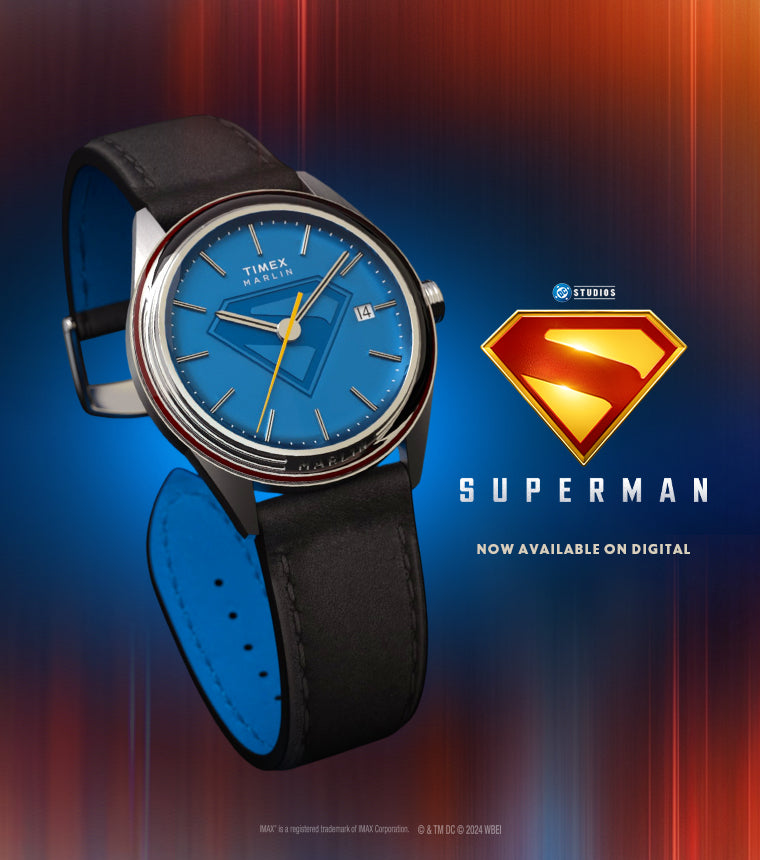 Timex Marlin x Superman special edition watch with blue dial featuring the Superman emblem, black leather strap, and Superman logo graphic in the background with text "Superman – Now Available on Digital".