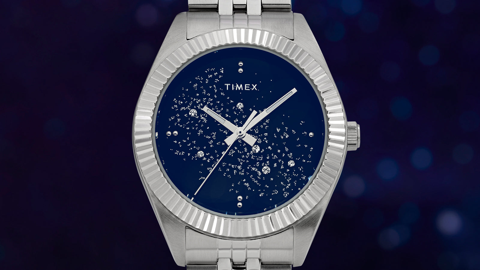 Close-up of the Timex Legacy dial with a midnight blue background and scattered crystal embellishments, evoking the look of constellations.