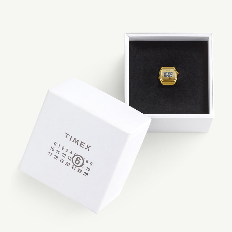 Timex x MM6 Maison Margiela T80 ring watch presented in an open white box with black velvet interior. The packaging features the MM6 calendar logo and Timex branding, emphasizing the collaboration’s sleek, luxury presentation.