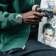 The James Brand x Timex GMT watch on wrist while holding a skateboard, emphasizing its durable and modern everyday style.