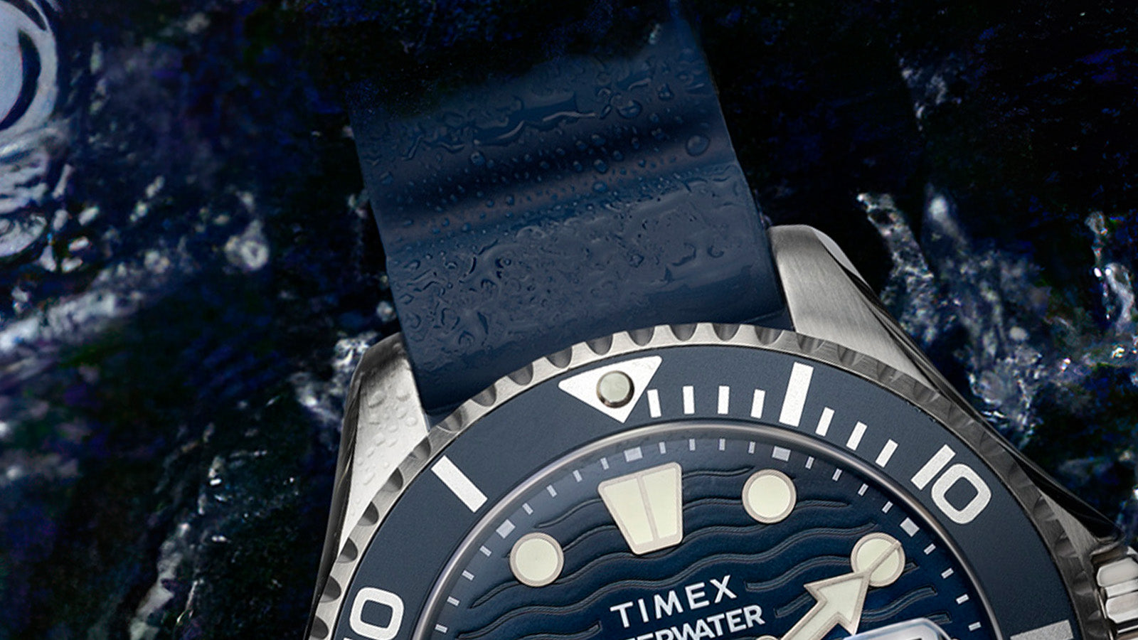Close-up of the Timex Deepwater Meridian 200’s textured blue strap and bezel, with water droplets emphasizing its durability and ocean-inspired design.