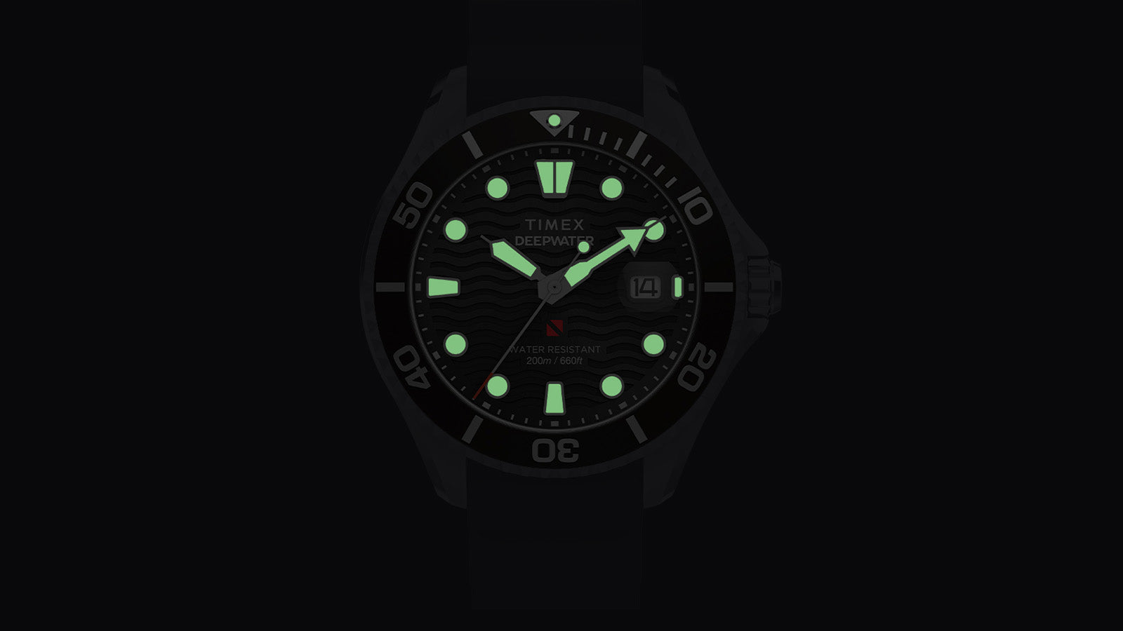 Timex Deepwater Meridian 200 dial glowing in the dark with luminous green hands and hour markers, demonstrating legibility in low-light conditions.