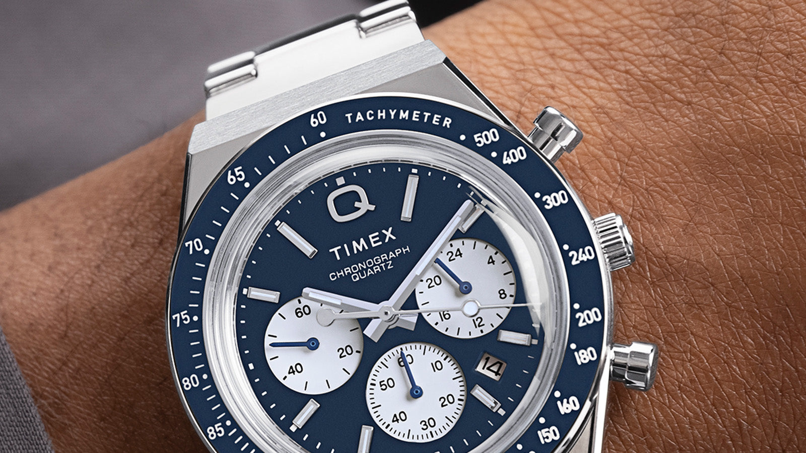 Detailed close-up of the Q Timex Chronograph’s blue dial with contrasting white sub-dials, tachymeter bezel, and polished case details.