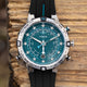 Front view of the Timex Expedition Tide-Temp-Compass highlighting the teal dial with wave detailing, white luminous hands, tide and temperature indicators, compass bezel, and date display at 6 o’clock.