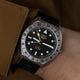 Close-up of the Timex Expedition North GMT Titanium Automatic on the wrist, emphasizing its rugged titanium case, black dial, and bold white indices.