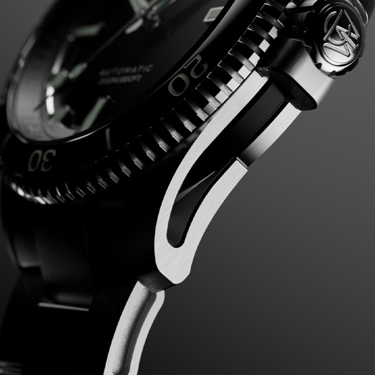 Macro side view of Timex Atelier watch case with brushed stainless steel finish, detailed crown engraved with "T" logo, and knurled bezel edge.