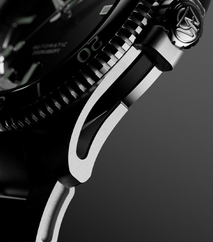 Macro detail of the case side and lug of the Timex Atelier watch, showing brushed and polished stainless steel surfaces.