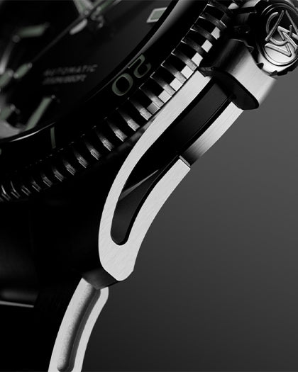 Macro detail of the case side and lug of the Timex Atelier watch, showing brushed and polished stainless steel surfaces.