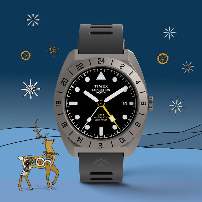 Timex Expedition North GMT watch with a black dial, gray case, and yellow hand displayed against a blue winter-themed background with a mechanical reindeer and snowflake gears.