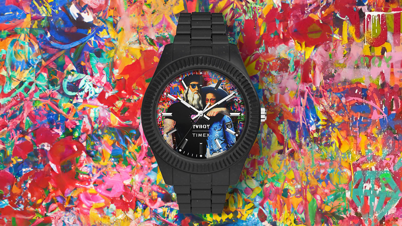 Close-up of the Timex Legacy Ocean x TVBOY watch highlighting its bold black bezel and street art-inspired dial. The background bursts with layered splashes of color and graffiti textures, reflecting TVBOY’s urban artistic style.