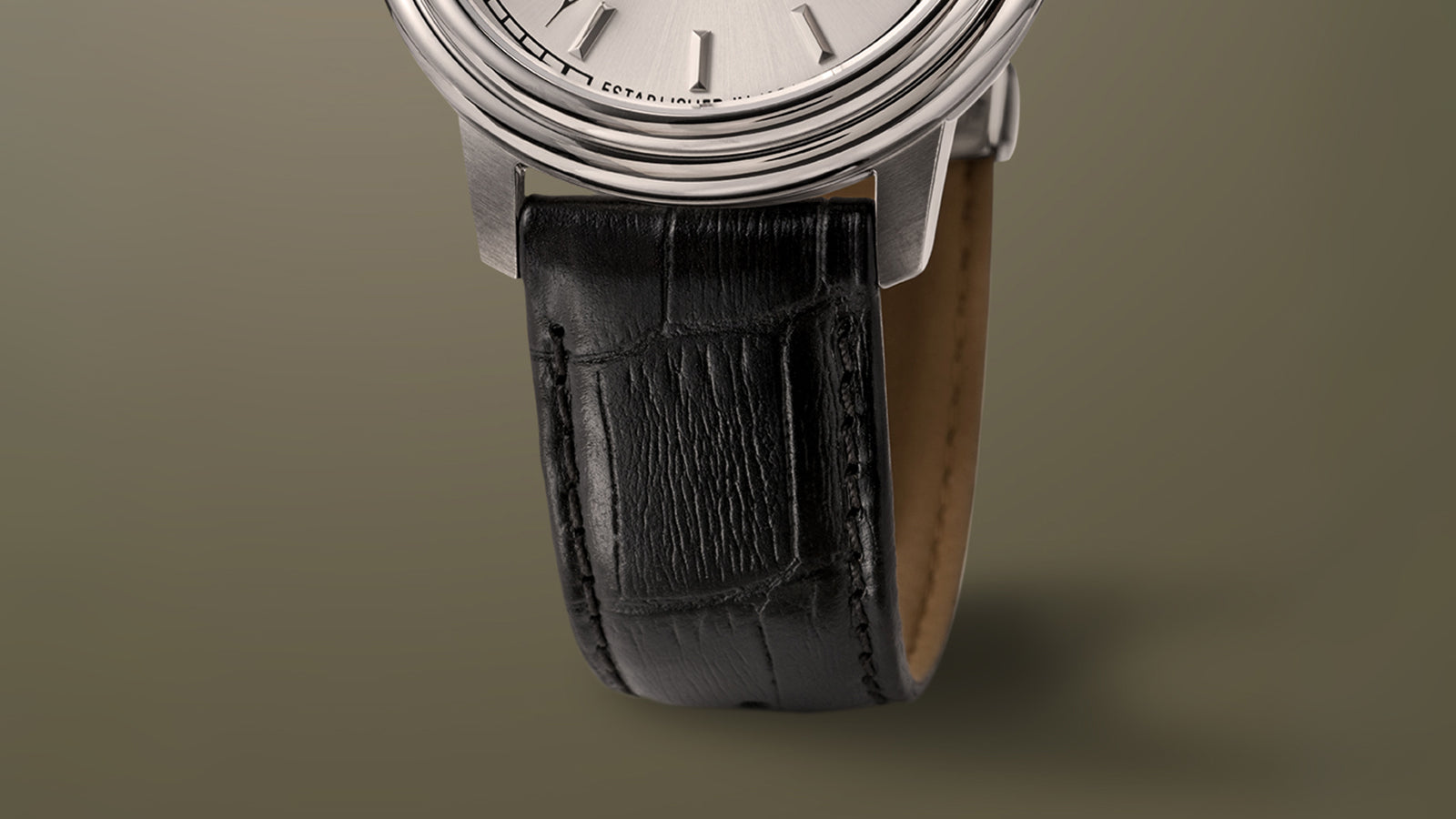 Macro view of the Timex Waterbury Metropolitan Automatic’s black leather strap with embossed grain and stitching detail.