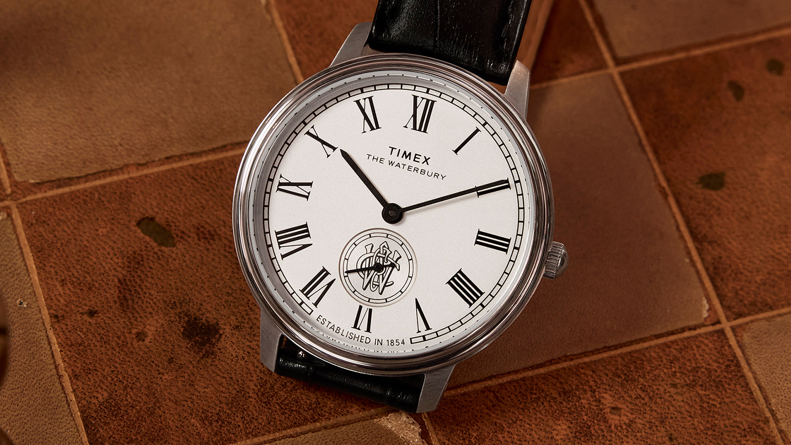 Macro shot of the Timex Waterbury Metropolitan Sub-Second dial featuring black Roman numerals, small seconds subdial, and the Waterbury crest.