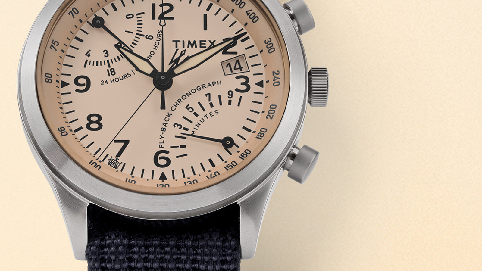 Close-up of the Timex Waterbury Traditional Fly-Back Chronograph beige dial featuring bold black numerals, sub-dials, and date window at 3 o’clock.