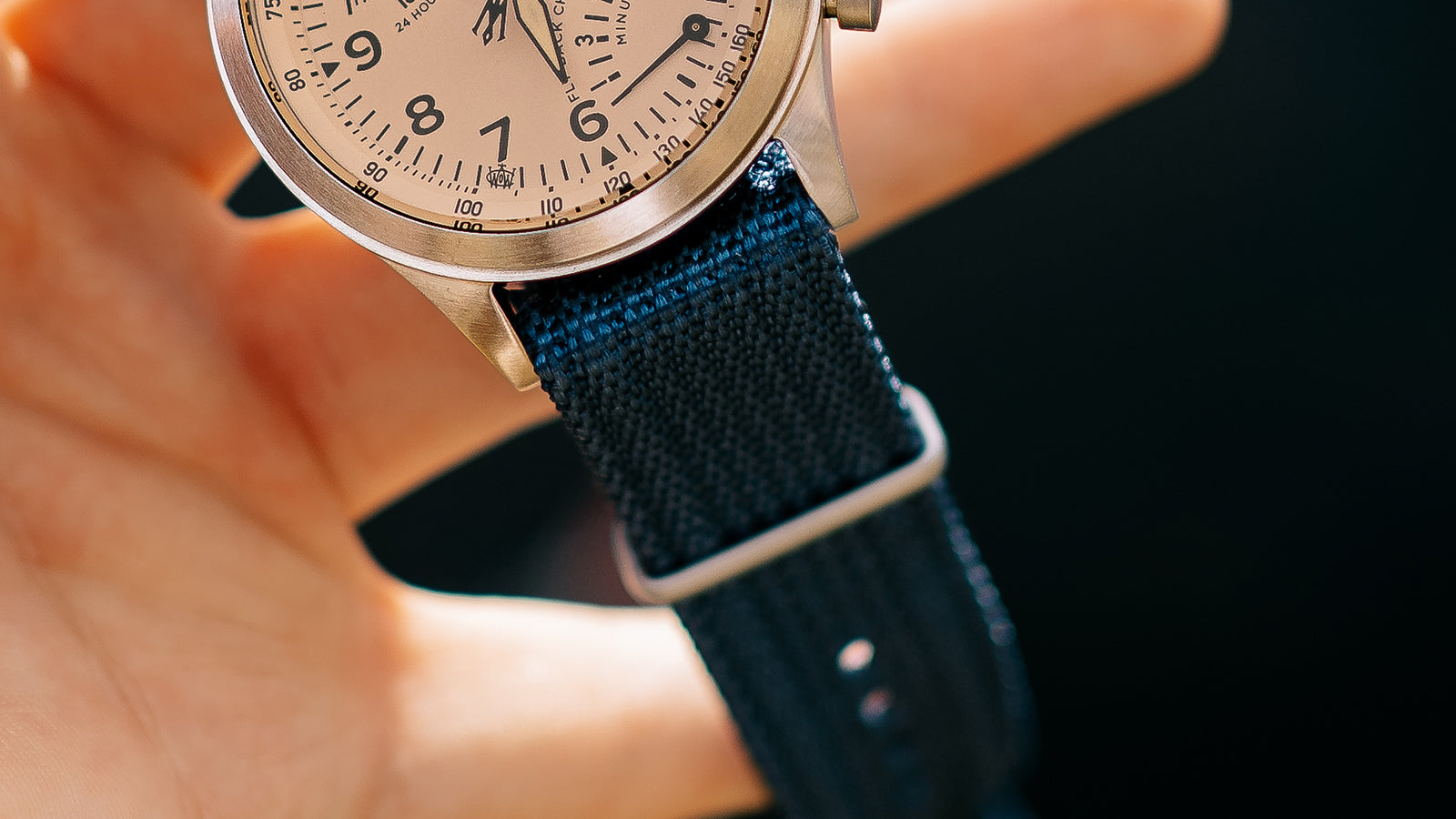 Close-up of the Timex Waterbury Traditional Fly-Back Chronograph’s durable navy woven fabric strap and brushed metal hardware.