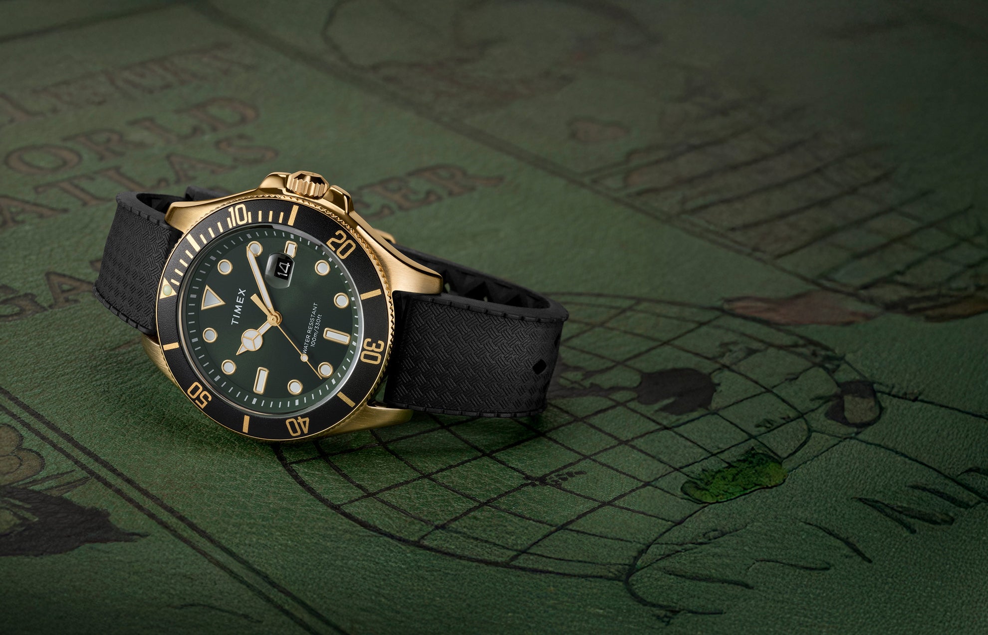 Timex Harborside Coast watch with a green dial, black bezel, and gold-tone stainless-steel case on a textured black strap, displayed on a vintage green world map background.