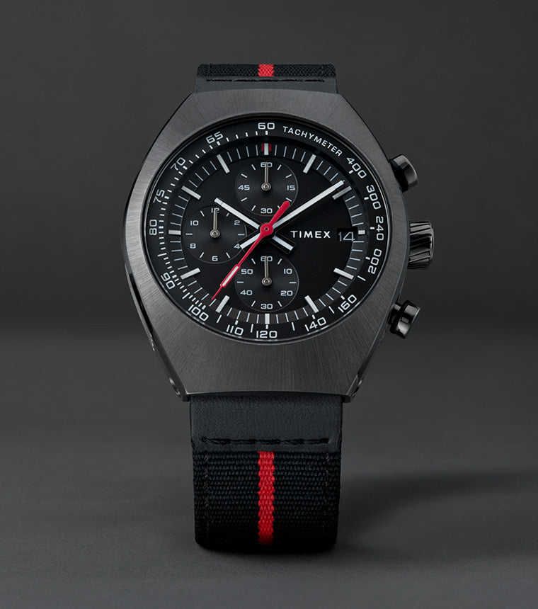 Front view of the Timex Legacy Tonneau Chronograph showing black dial with white markers, red seconds hand, and tachymeter scale.
