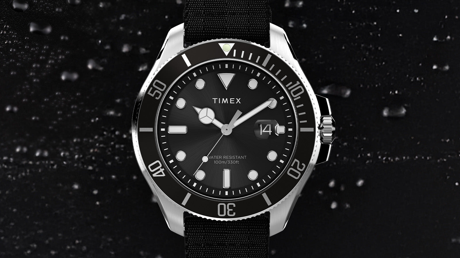Front view of the TIMEX® Harborside Coast watch highlighting its black rotating bezel, luminous markers, and 100-meter water resistance.