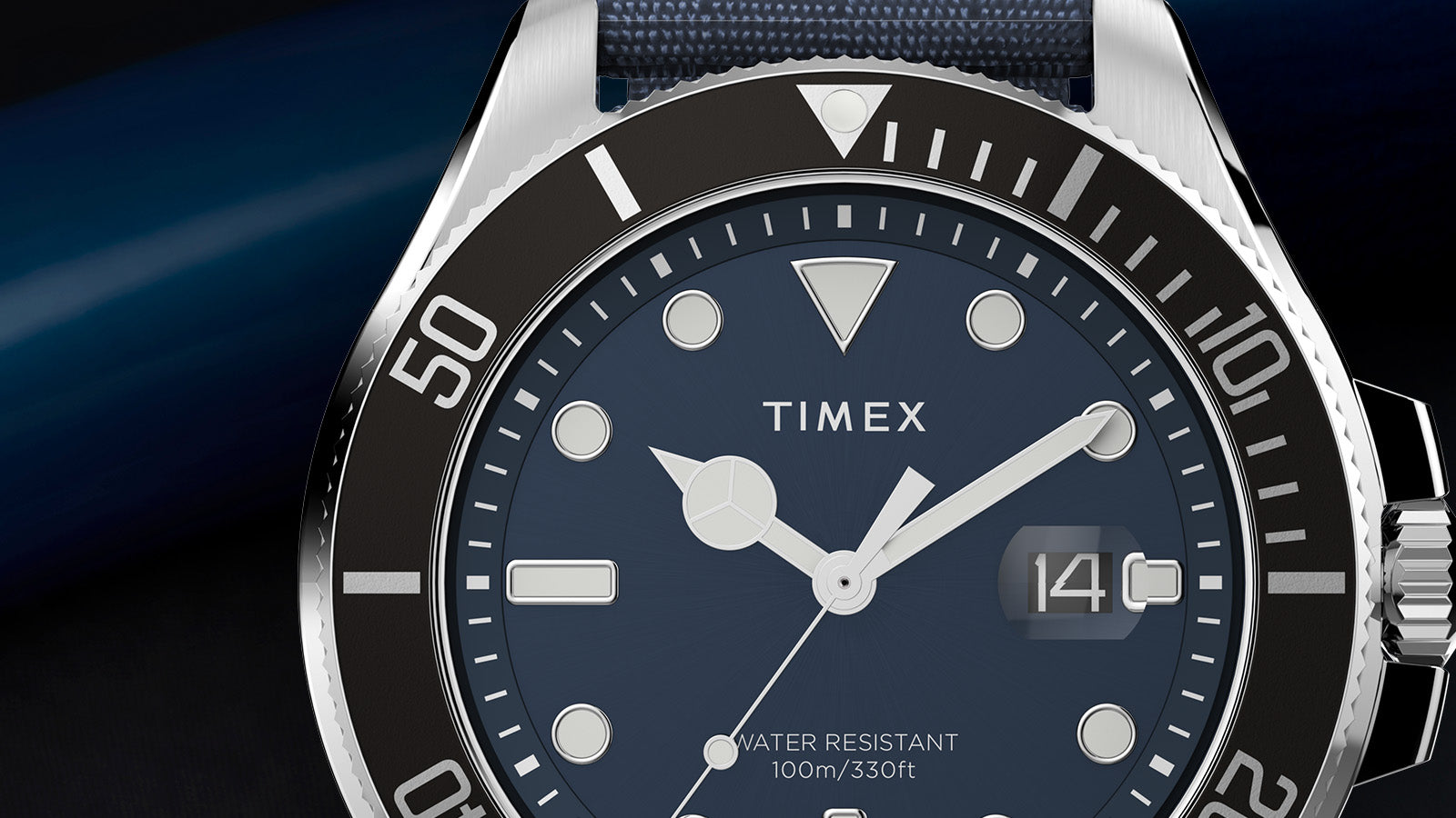 Detailed shot of the TIMEX® Harborside Coast watch showcasing its black rotating bezel, silver-tone hands, and 100-meter water resistance text.