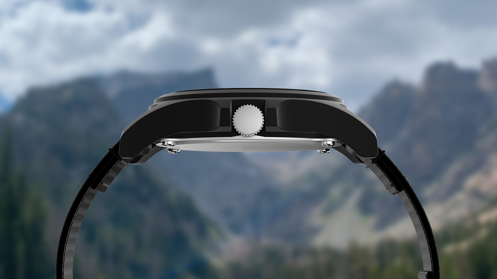 Side profile of the Timex Rocky Mountain National Park watch, highlighting the matte black case and crown with blurred mountain scenery in the background.