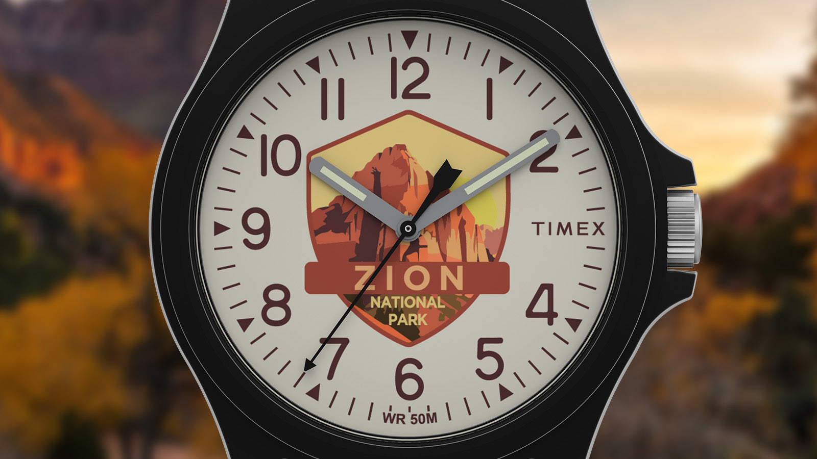 Close-up of the Timex Zion National Park watch face featuring canyon artwork in warm tones of red and orange with bold numerals and luminous hands.