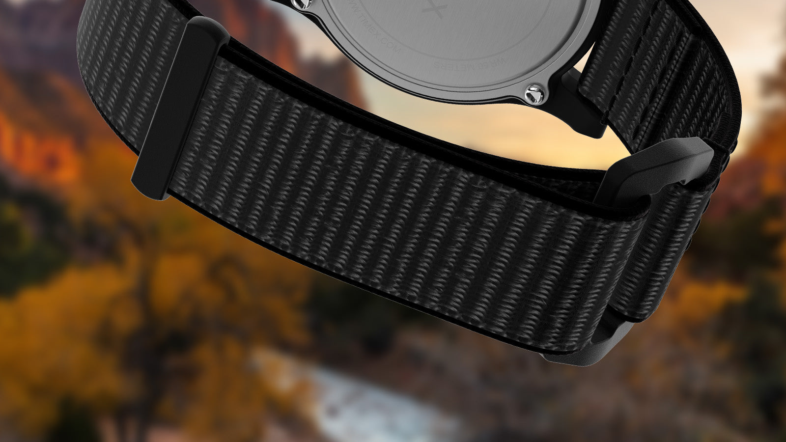 Detailed view of the black woven strap of the Timex Zion National Park watch, shown against a softly blurred canyon landscape at dusk.