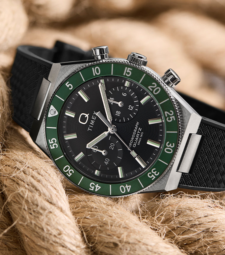 Q Timex® Continental Chronograph watch with a green bezel, black dial, and black rubber strap, styled on coiled rope.
