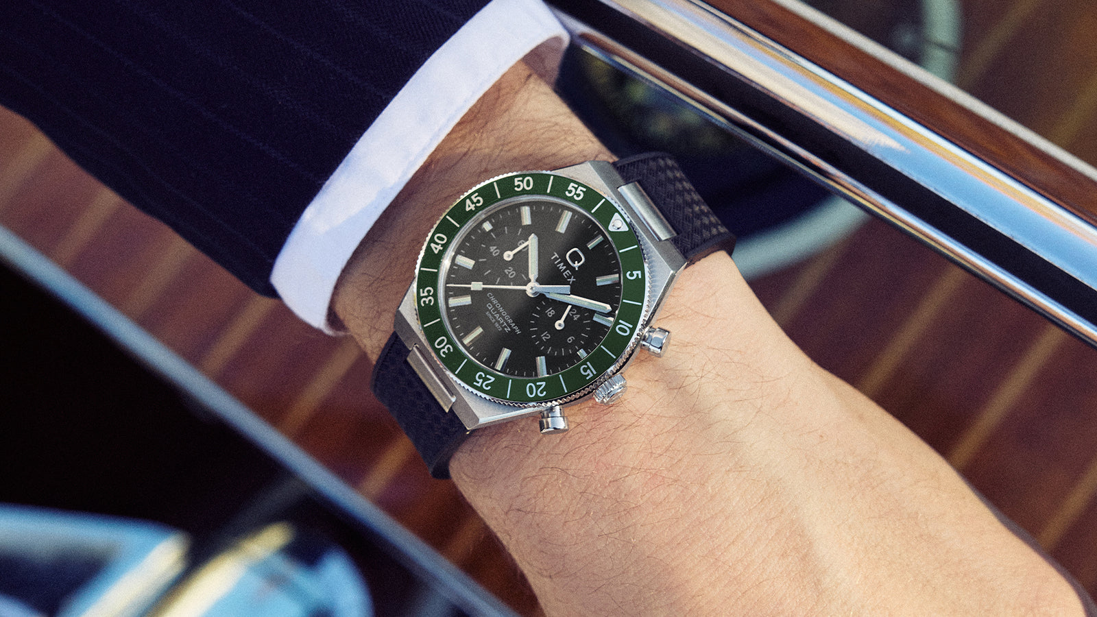 Q Timex® Continental Chronograph worn on the wrist, featuring a green bezel, black dial, and chronograph subdials.
