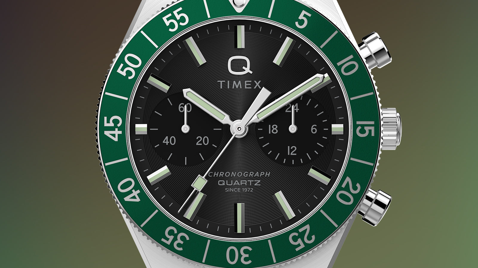 Close-up of the Q Timex® Continental Chronograph dial with green rotating bezel, luminous hour markers, and chronograph subdials.