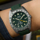 Timex Expedition Pioneer Titanium Automatic GMT watch worn on wrist with green fabric strap and bold outdoor styling.