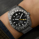 Detailed wrist shot of the Expedition® Pioneer Titanium Automatic GMT with titanium case, 24-hour bezel, and bracelet.
