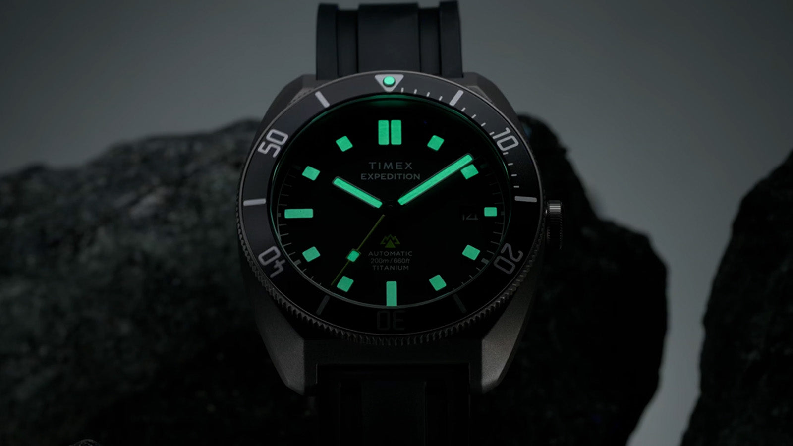 Timex Expedition Pioneer Automatic watch glowing in the dark with luminous hands and markers