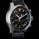 Close-up of Timex Waterbury Ace Fly-Back Chronograph black dial showing subdials, tachymeter scale, and luminous hands