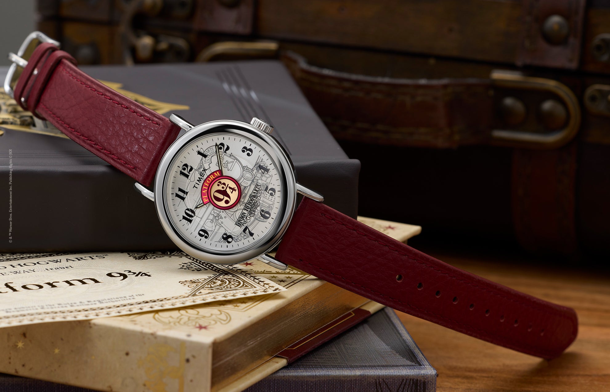 Harry Potter x Timex Weekender Platform 9¾ watch with silver-tone case and red leather strap displayed on Hogwarts books and ticket.
