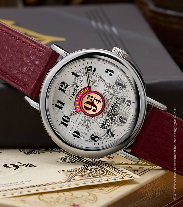 Harry Potter x Timex Weekender Platform 9¾ watch with silver-tone case and red leather strap displayed on Hogwarts books and ticket.