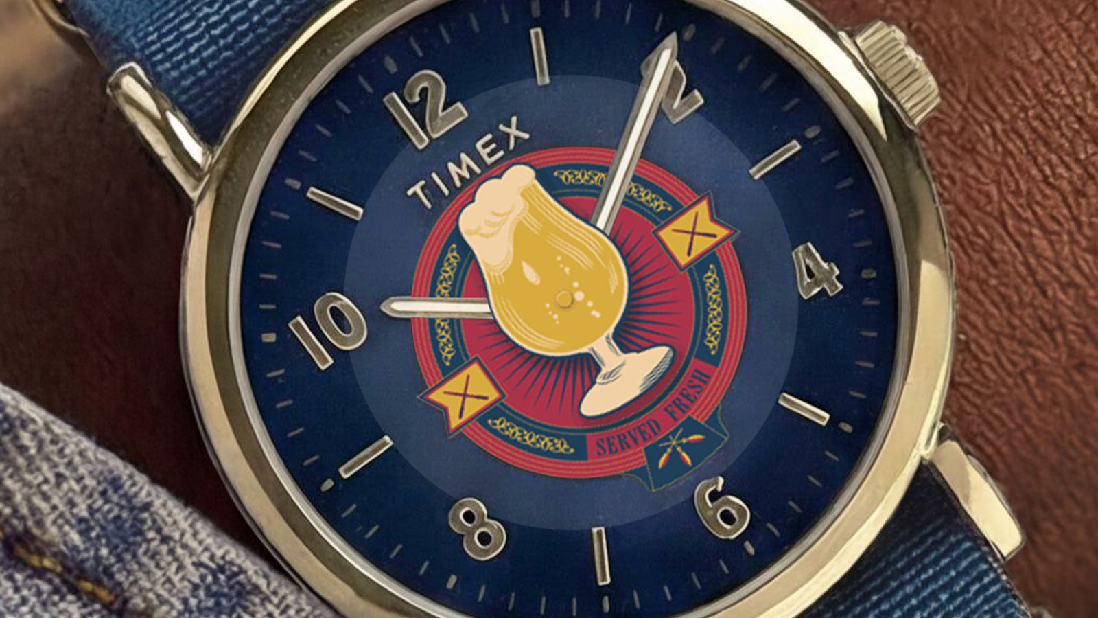 Close-up of Harry Potter x Timex Weekender Butterbeer watch on wrist showing blue strap and Butterbeer-themed dial.