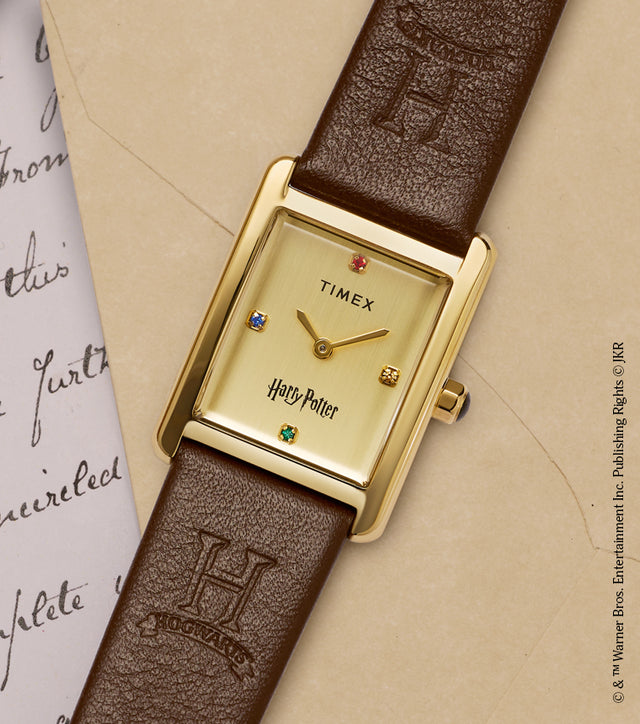 Harry Potter x Timex Hailey Hogwarts watch with gold-tone rectangular case displayed on a Hogwarts letter with red wax seal.