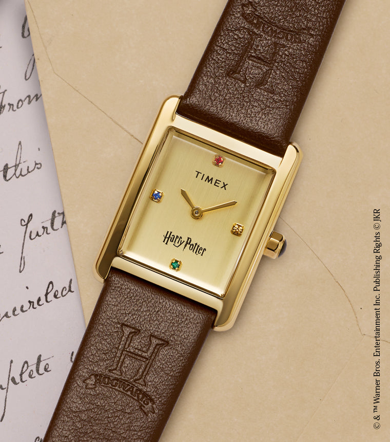 Harry Potter x Timex Hailey Hogwarts watch with gold-tone rectangular case displayed on a Hogwarts letter with red wax seal.