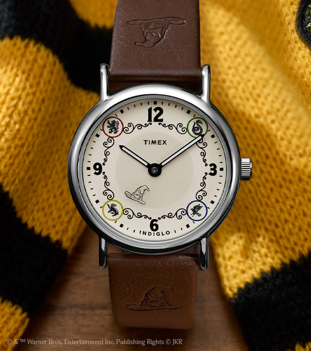 Harry Potter x Timex Weekender Hufflepuff House watch with brown leather strap displayed beside a yellow and black Hufflepuff scarf.
