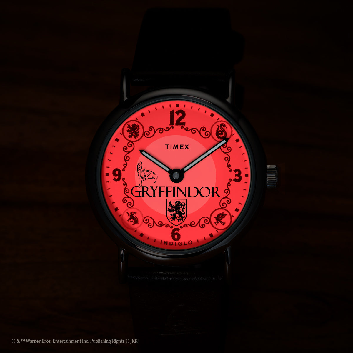 Harry Potter x Timex Weekender Gryffindor House watch illuminated in red INDIGLO night-light mode.